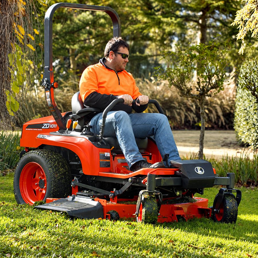 Operator mowing grass on a Kubota ZD-series zero-turn mower